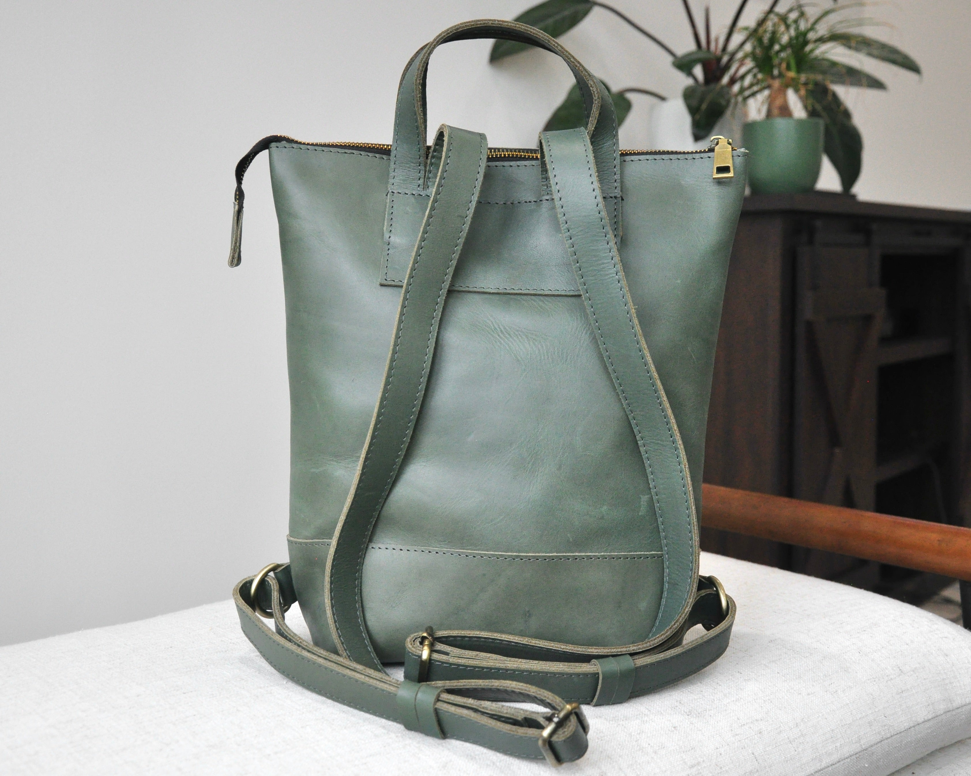 Small, olive green, genuine full-grain leather backpack for women with zipper, durable and handmade in Ethiopia